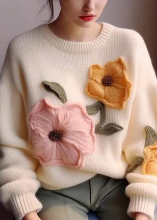 Strikket sweater med blomsterapplikation